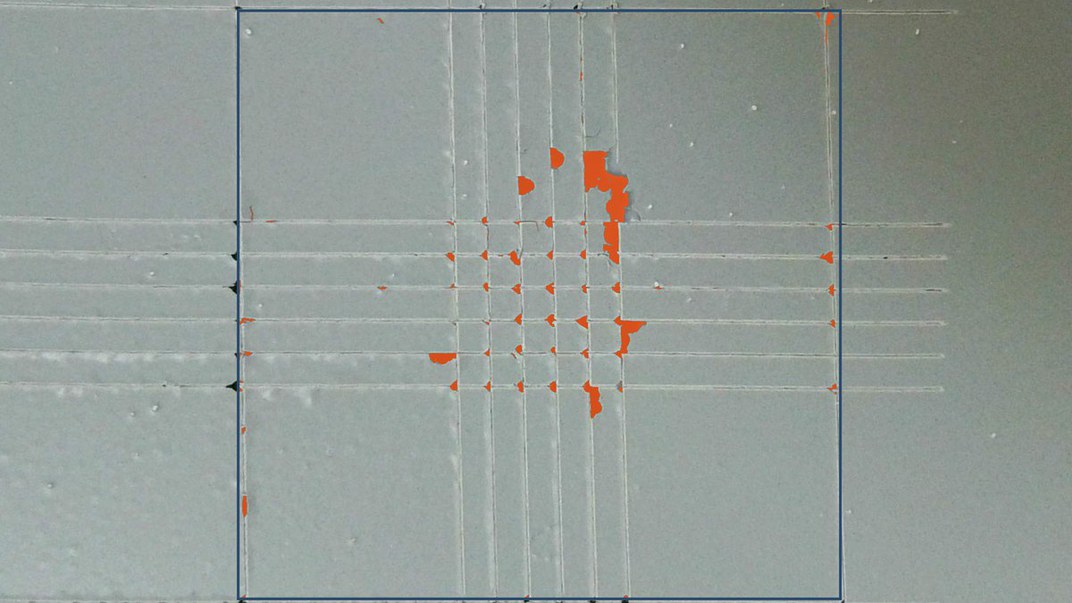 A cross-cut panel evaluated by the tool: the delaminated pixels are marked in orange inside the region you defined.