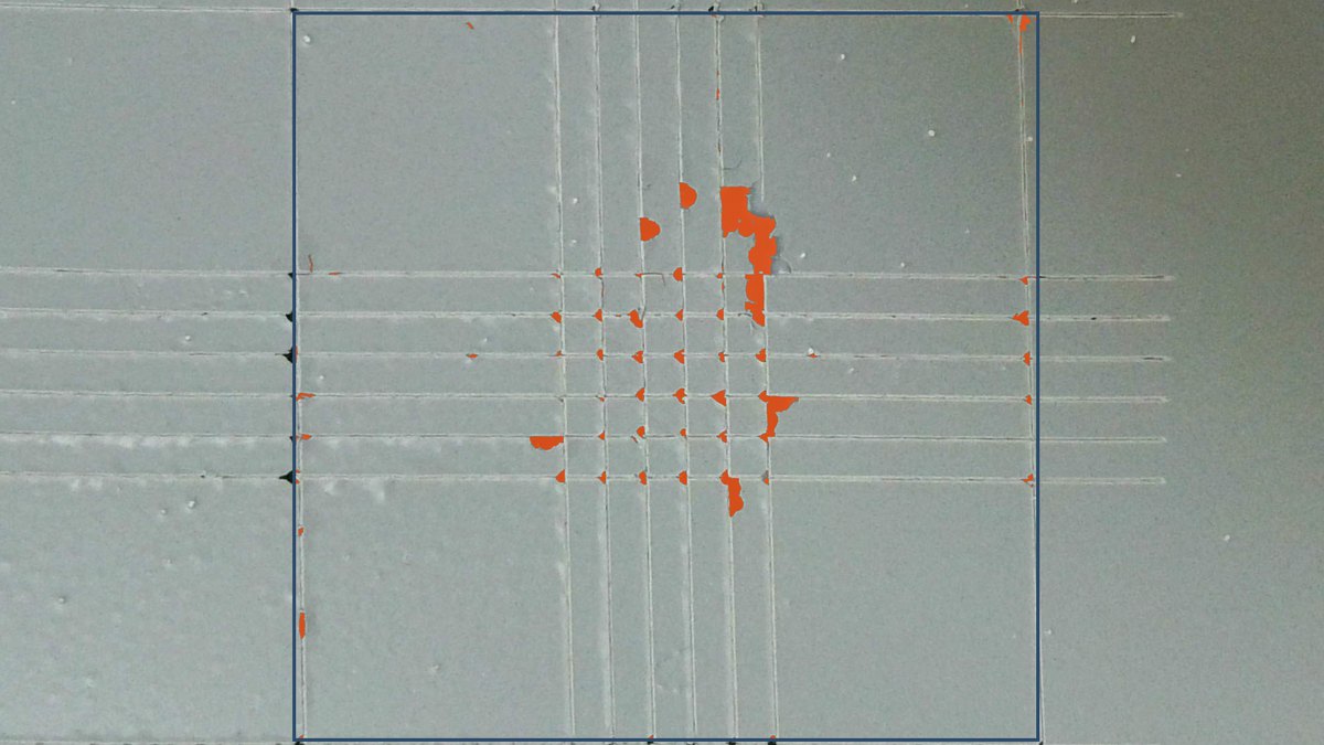 Cross-cut panel with the delaminated pixels marked in orange inside the evaluated region